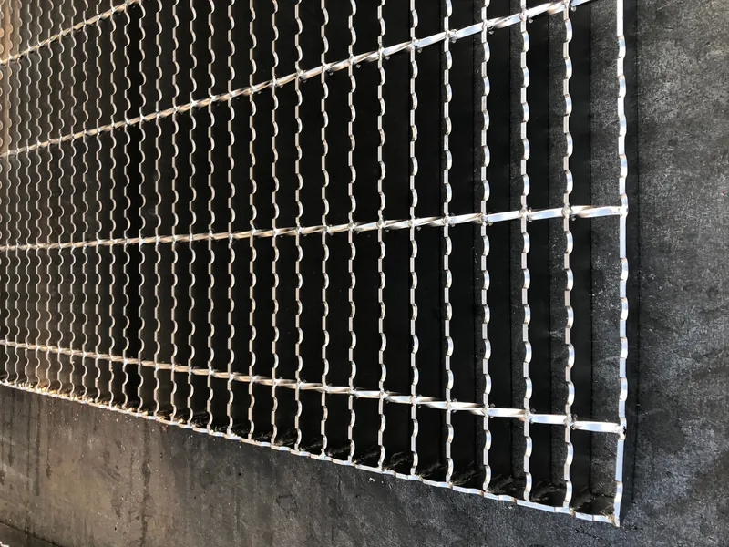 Serrated steel grating surface showing teeth cut into the bearing bars